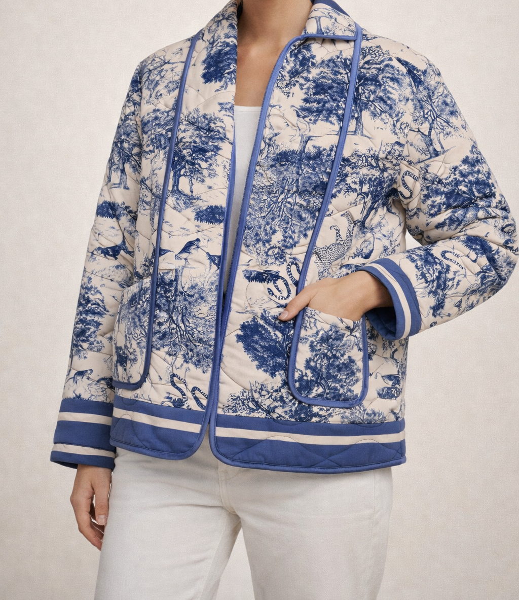 Exklusive Steppjacke in Blau-Weiß mit elegantem Toile-de-Jouy Safari-Design. Hochwertig gesteppt, modern geschnitten und ein stilvoller Blickfang für trendbewusste Looks.